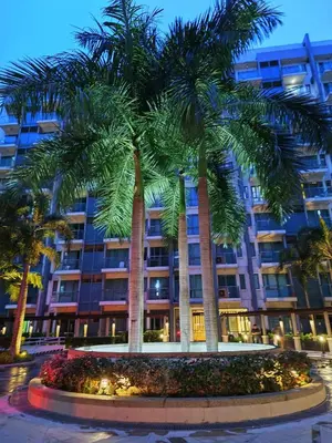 a palm tree in front of a building at Two Palmtree Villas cluster3 rooms across NAIA terminal 3 in Manila