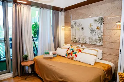 a bedroom with a bed with pillows on it at Azure Urban Resort Staycation 1 Bedroom Beach View, 18th floor in Manila