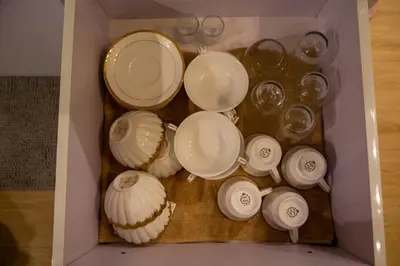 a drawer filled with white plates and dishes at Azure Urban Resort Staycation 1 Bedroom Beach View, 18th floor in Manila