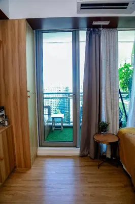 a bedroom with a large sliding glass door with a balcony at Azure Urban Resort Staycation 1 Bedroom Beach View, 18th floor in Manila