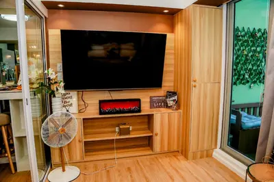 a living room with a flat screen tv and a fan at Azure Urban Resort Staycation 1 Bedroom Beach View, 18th floor in Manila