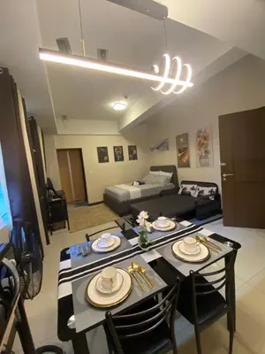 a living room with a table and a couch at A&G Condotel at 101newport Right across NAIA T3 in Manila