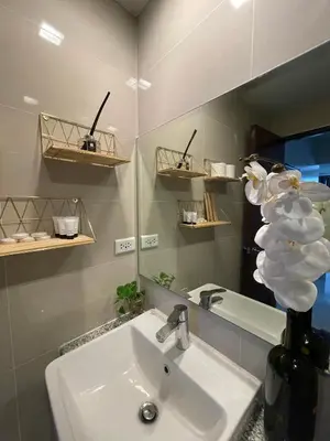 a bathroom with a sink and a vase with flowers at Executive luxury 2BR Condo Unit in McKinley Hill BGC Taguig in Manila