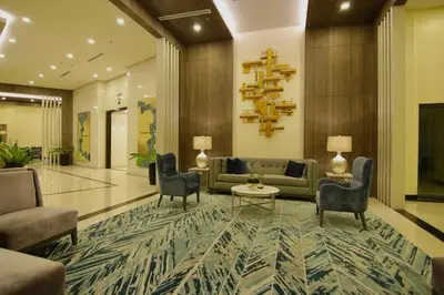 a lobby with a couch and chairs and a table at Executive luxury 2BR Condo Unit in McKinley Hill BGC Taguig in Manila