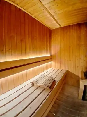 an empty wooden sauna with a bench in it at Spacious 1BR Milano by Versace in Makati in Manila