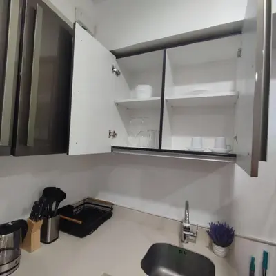a kitchen counter with a sink and a mirror at Spacious 1BR Milano by Versace in Makati in Manila