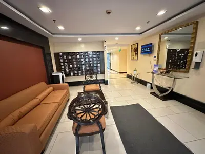 a lobby with a couch and chairs in a store at 1-Bedroom condo with pool across NAIA Terminal 3 in Manila