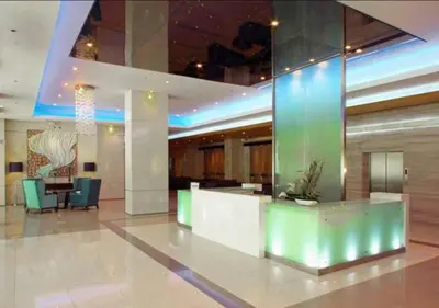 a lobby with a reception desk in a building at Cobblestone City Stays - SM Mezza 1 Residences in Manila