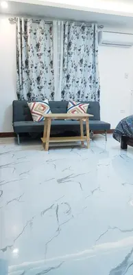 a living room with a couch and a table at 1 MARY's STAYCATION Condo Type with Balcony 2 person in Tanza