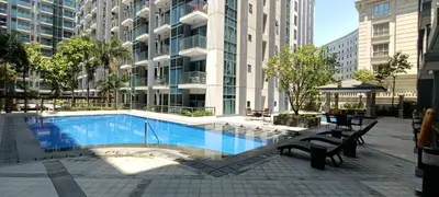 a swimming pool in the middle of a building at 1 bedroom Condotel in front of terminal 3 Airport in Manila