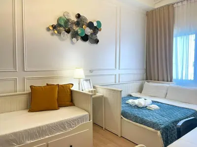 a small bedroom with a bed and a window at Belle 4621 by TPS in Manila