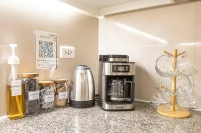 a kitchen counter with a coffee maker and a coffeemaker at Korea In The City Staycation with Pool, Gym and More in Manila
