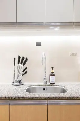 a kitchen sink with a bottle of soap on it at Korea In The City Staycation with Pool, Gym and More in Manila
