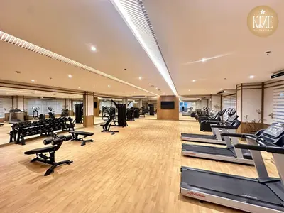a gym with rows of treadmills and exercise bikes at Kize Staycation in Manila