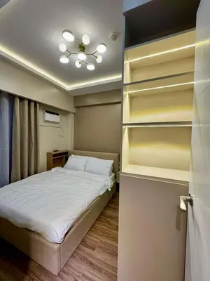 a small bedroom with a bed and a closet at Kize Staycation in Manila