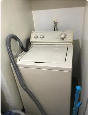 a small white stove with a hose at Montecito unit near airport in Manila