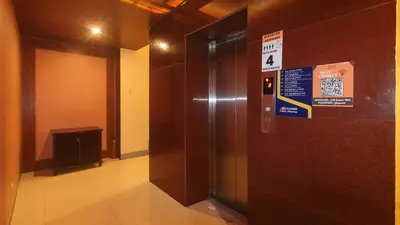 a elevator in a building with a sign on it at RedDoorz Premium at JjimJBang Hotel Spa in Manila
