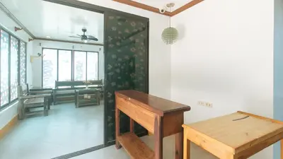 a room with a table and a bench in it at RedDoorz at Joels Apartelle in Calaboso