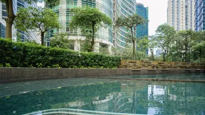 a swimming pool in a city with tall buildings at Premium 1BR unit at The Avant in Manila