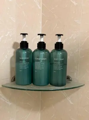 two green bottles on a shelf in a bathroom at Contemporary Studio at Avant BGC in Manila