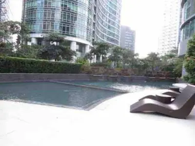 a sculpture in front of a fountain in a city at Contemporary Studio at Avant BGC in Manila