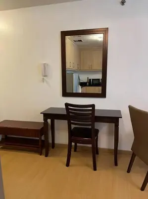 a dining room table with a mirror and a chair at Contemporary Studio at Avant BGC in Manila