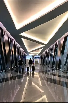 two people walking through an airport with their luggage at ONE PALM TREE VILLAS-Hyuna Place, Acros NAIA T3 in Manila