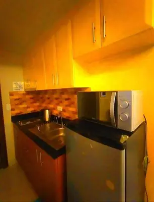 a kitchen with a sink and a microwave at ONE PALM TREE VILLAS-Hyuna Place, Acros NAIA T3 in Manila