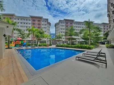 a swimming pool in the middle of a building at Lakwatsero Caviteño Suites in Trece Martires