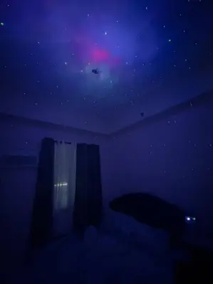 a dark room with a view of a purple sky at Zenrise Staycation Condo in SMDC Hope Residences Trece Martires in San Agustin