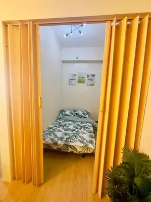 a bedroom with a bed in a room with yellow curtains at Zenrise Staycation Condo in SMDC Hope Residences Trece Martires in San Agustin