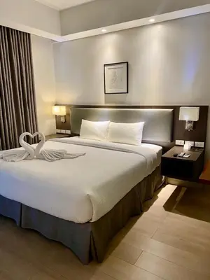 a bedroom with a large bed in a room at GBA Condotel at Bonifacio Civic Center Tower in Manila