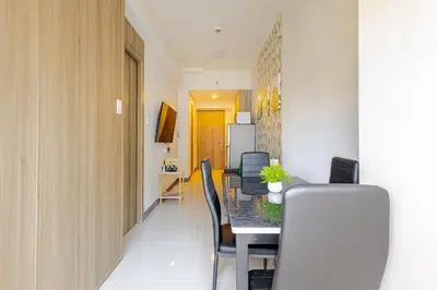 a dining room with a table and chairs at The Prestige Bayview with Balcony in Manila