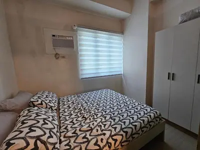 a small bedroom with a bed and a window at Q Workcation WFH Staycation in Manila