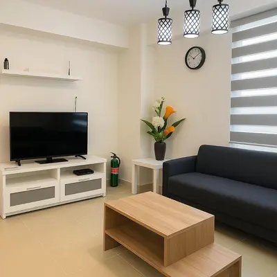 a living room with a couch and a tv at Kasara Urban Resort & Residences in Manila