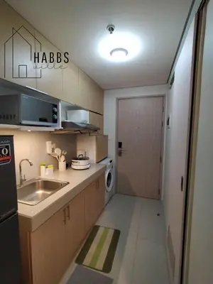 a small kitchen with a sink and a washer and dryer at HabbsVille at Green 2 Residences by SMDC Dasmarinas Cavite in Dasmariñas