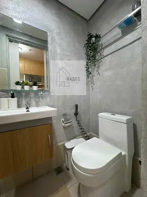 a bathroom with a white toilet and a sink at HabbsVille at Green 2 Residences by SMDC Dasmarinas Cavite in Dasmariñas