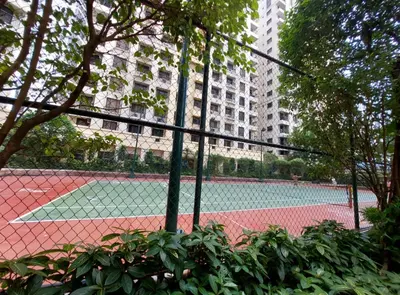a tennis court in the middle of a city at 1BR Condotel - Forbes Town Road near St Lukes BGC Taguig in Manila