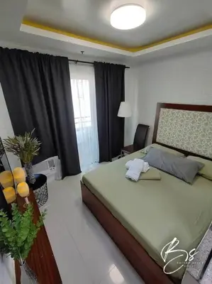 a bedroom with a large bed in a room at Birch Tower by Bright Space Manila in Manila