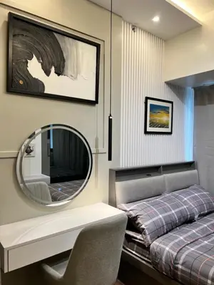 a bedroom with a bed and a mirror at AM Condotel at Air Residences in Manila