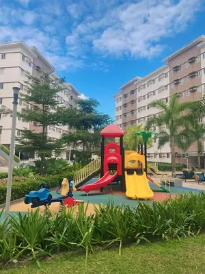 a playground with a slide in a park at Anne's Place at Hope Residences - SMDC Condo Beside SM Trece in Trece Martires
