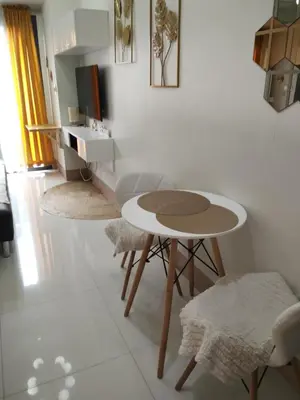 a white room with a table and two chairs at Staycation At Shore by LAYANDY in Manila