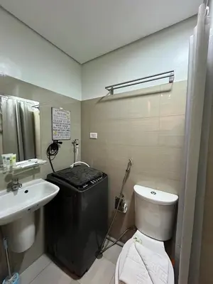 a bathroom with a white toilet and a sink at SMDC Good Stays Shore 2 - Unit 1289 Tower 2 in Manila