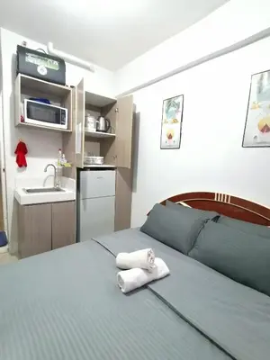 a bedroom with a bed with a towel on it at pierrecondotel in Manila