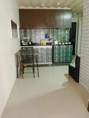 a kitchen with a table and chairs in a room at Kassel DORZ Hostel Bldg 16 Condostaycation in Manila