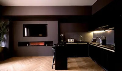 a black kitchen with a counter and a fireplace at Luxury Apartment with PA, Skyline View & Top Amenities in Manila