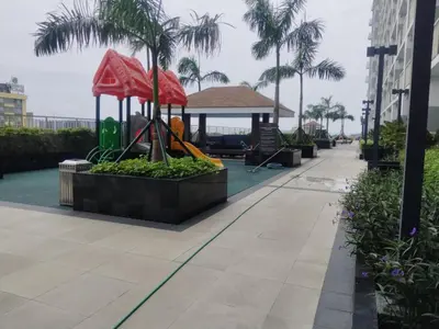 a playground on the side of a building with palm trees at 2br Condo Coast Residence near MOA NAIA Ayala WTC in Manila