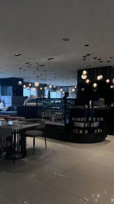 a restaurant with tables and a bar with lights at Staycation at ACQUA The Hotel Residences Novotel Tower in Manila