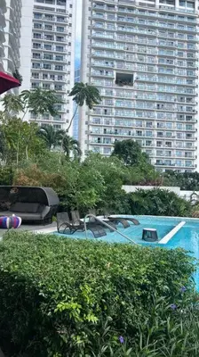 a swimming pool in a city with tall buildings at Staycation at ACQUA The Hotel Residences Novotel Tower in Manila