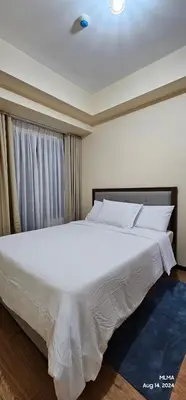 a large white bed in a room with a window at Serenity by Zen Residences at The Radiance Manila Bay in Manila